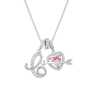 Close-up of silver letter L and pink heart pendant necklace with shimmering crystals