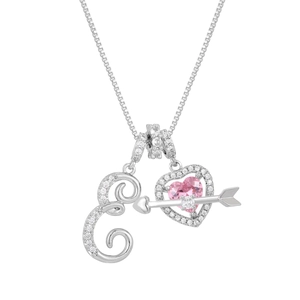 Macro detail of silver necklace with pink heart stone and crystal paved letter E
