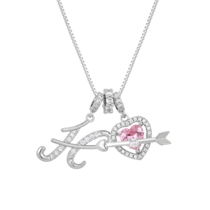 Macro detail of silver necklace with pink heart gem and zircon paved letter H pendant