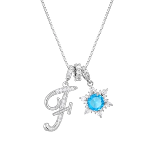 Detailed close-up of silver letter F pendant with snowflake and blue zircon stone