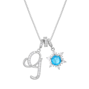 Macro shot of silver-tone box chain necklace with zircon G letter and blue snowflake pendant