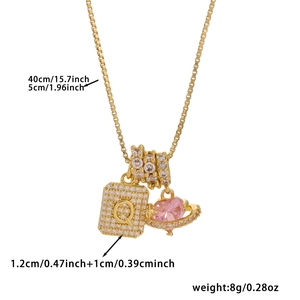 Detail of 45cm gold box chain necklace with zircon letter Q square and pink heart charm