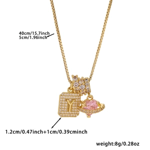 Detail view of 40cm gold necklace with zircon square letter Y and pink heart charms