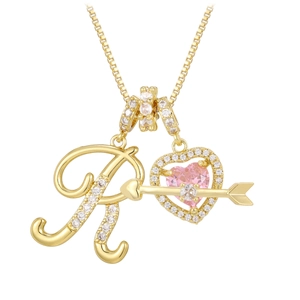Macro shot of gold letter R pendant with pink heart zircon and sparkling crystal arrow