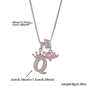 Detail of silver crown letter Q necklace with pink heart planet pendant and cz accents