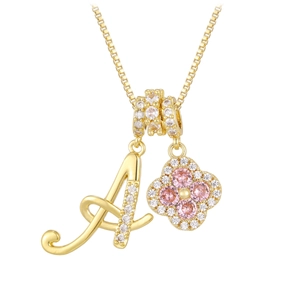Detail of golden clover pendant with pink gemstones and diamond-set letter A