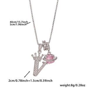 Close-up of crown letter V pendant with pink planet stone and white zircon stones