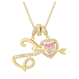 Detail of stethoscope pendant necklace with pink heart zircon and gold arrow jewelry design