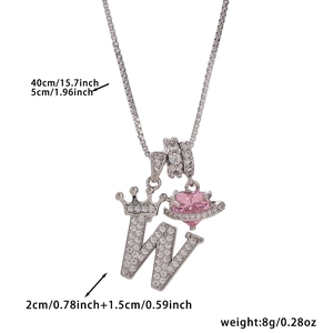 Macro detail of silver crown letter W pendant with pink heart and dimensions shown