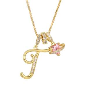 Detailed close-up of gold letter F pendant with pink heart planet and micro-pave crystals