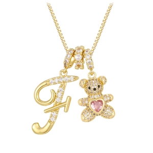 Detail of bear pendant with pink heart and pavé crystal letter F on gold box chain
