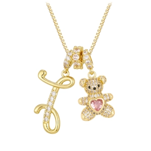Detail of bear pendant with pink heart stone and crystal encrusted letter J on gold chain