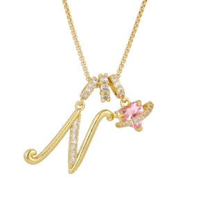 Gold letter N necklace with pink heart planet pendant and sparkling cubic zirconia