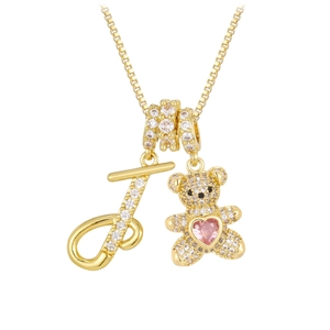 Detail of a gold bear pendant with pink heart stone and crystal letter J on box chain