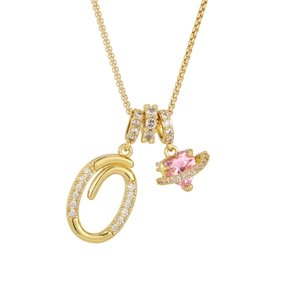 Detailed shot of gold-plated necklace with letter Q pendant and pink heart Saturn charm