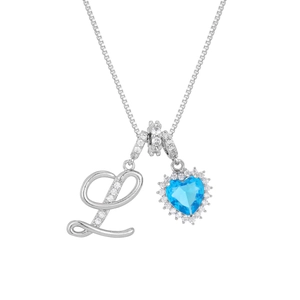 Close-up of silver letter L pendant and heart-shaped blue zircon stone with diamond halo