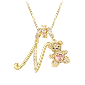 Detail of bear pendant necklace with letter N and pink heart-shaped stone