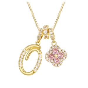 Macro shot of 18K gold plated clover necklace with pink zircon and letter O pendant