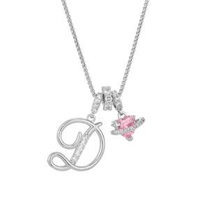 Close-up of silver D-letter pendant and pink heart planet charm with cubic zirconia