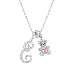 Macro detail of silver bear pendant with pink heart stone and crystal letter E charm
