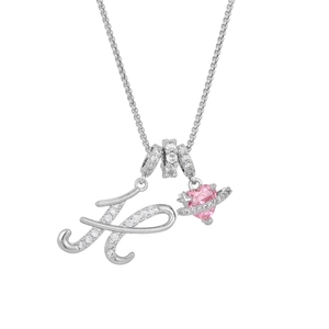 Detail of pink heart planet pendant with silver letter K and sparkling crystals