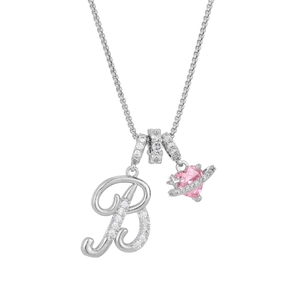 Macro detail of silver necklace with zircon letter B and pink heart Saturn pendant