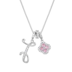 Macro detail of silver clover pendant with pink crystals and letter J cursive charm