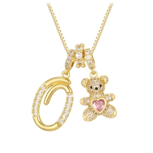Detail of bear pendant with pink heart stone and crystal paved letter O on gold chain
