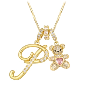 Close-up of golden bear and letter P pendants with cubic zirconia and pink heart stone
