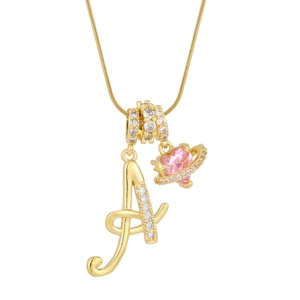 Close-up of golden letter A pendant and pink heart orb charm on a snake chain