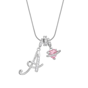 Macro detail of silver letter A pendant with pink heart planet and sparkling cubic zirconia
