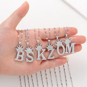 Détail des pendentifs lettres couronnées B S K Z O M avec zircons étincelants