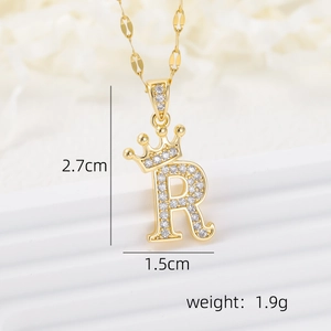 Macro detail of gold crown letter R pendant with cubic zirconia and size dimensions