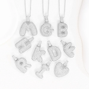 Detailed close-up of icy silver chunky alphabet pendants with micro-pave cubic zirconia
