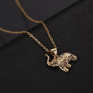 Detailed close-up of golden elephant pendant with multicolored zircon inlay and swirl patterns