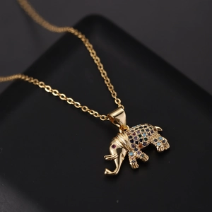 Macro shot of gold elephant pendant necklace with colorful cubic zirconia inlay