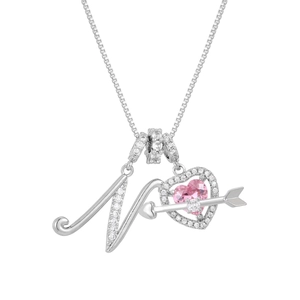 Macro shot of silver letter N necklace with pink heart pendant and cubic zirconia