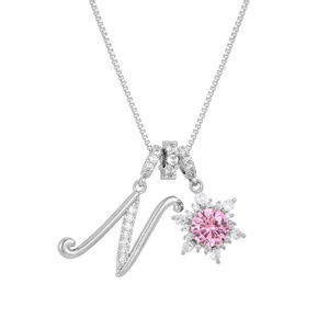 Detail of silver letter N pendant necklace with pink gemstone and snowflake accents