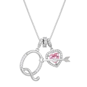 Macro detail of silver necklace with zircon letter Q and pink heart arrow pendant