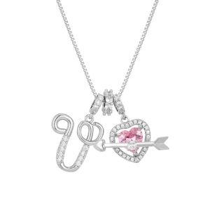 Macro detail of Cupid arrow heart necklace with pink zircon and paved letter U pendant