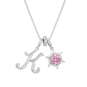 Detail of silver letter K pendant and sunburst charm with pink gemstone on box chain
