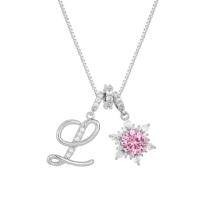Macro detail of silver necklace with crystal letter L and pink snowflake flower pendant