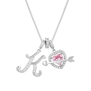 Close-up of silver K-letter pendant with pink heart stone and zircon arrow details