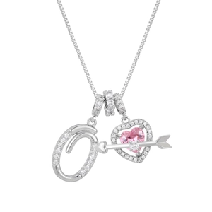 Detail of pink heart gemstone necklace with arrow design and pavé letter O pendant