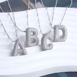 Detailed view of bubble initial pendants A to D with pavé cubic zirconia inlay