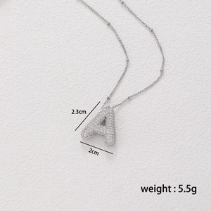 Detail shot of bubble letter A pendant with zircons showing dimensions 2.3cm by 2.0cm