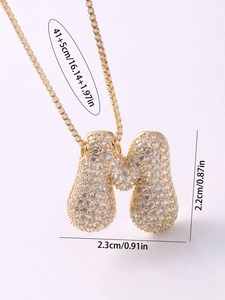 Detailed view of rhinestone paved initial M necklace with size dimensions in cm and inches