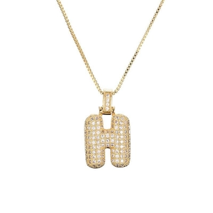 Détail du pendentif lettre H dorée bombée avec zircons sertis sur chaîne box