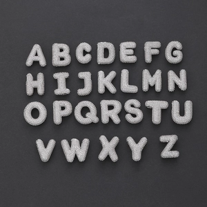 Macro view of iced-out 26 capital letters with micro-pave white zircon stones