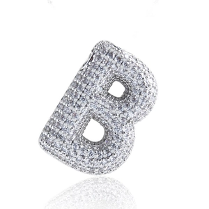 Macro detail of iced-out B-letter pendant with micro-paved zircons in hip hop style